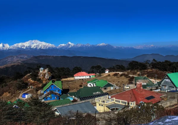 Colorful village huts with the snow-capped Kangchenjunga mountain range in the background on the Sandakphu Phalut Trek
