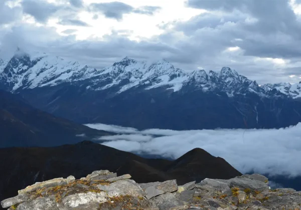 Snow-capped Himalayan mountains above a sea of clouds on the Singalila Ridge Trek.